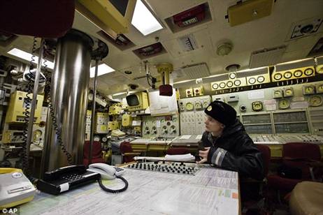 At the helm: A Russian sailor sits in the control room of the Yekaterinburg submarine at an earlier date