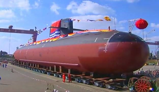 Type 039B Yuan-class submarine during rollout at the Jiangnan Shipyard on Changxing Island. Note the long white line in the draft markings, which designates the submarine’s normal surface waterline. Also note the low-frequency passive flank array just above the keel blocks. 