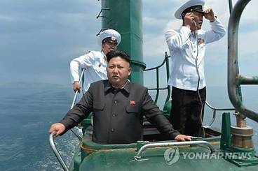This Rodong Sinmun photo released on June 16, 2014, shows North Korean leader Kim Jong-un aboard a submarine during his visit to the North's Naval Unit 167 stationed on the east coast. (Yonhap)  