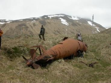 Biologist Jeff Williams near a midget submarine on Kiska Island in the far west Aleutians in 2004. Photo by Ned Rozell.